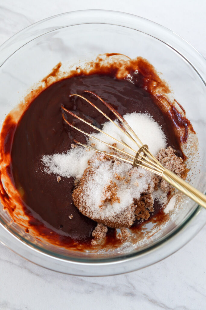 Sugar being whisked into melted chocolate. 