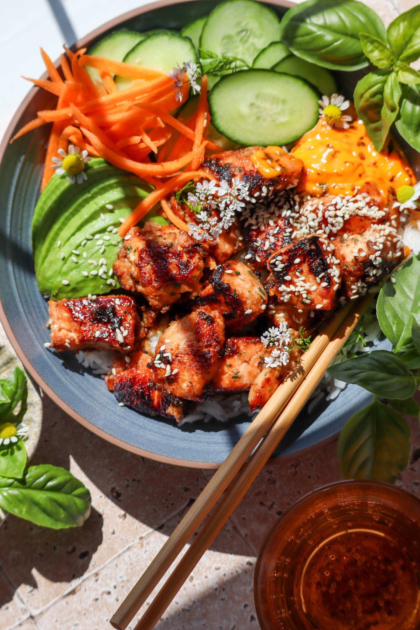 Air fryer salmon bites bowl with rice, avocado, cucumbers and carrots